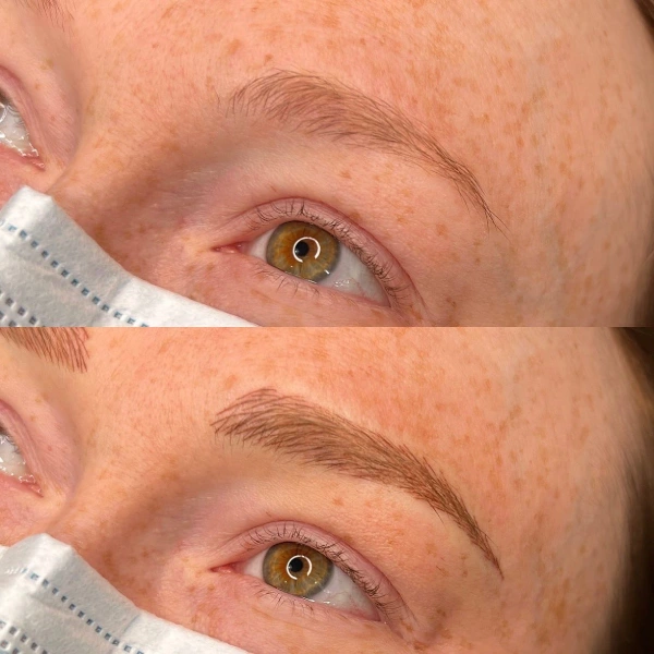 A woman with brown eyes and brows being tattooed.