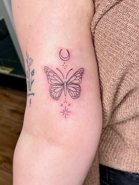 A butterfly tattoo is shown on the arm.