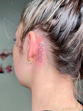 A woman with a heart tattoo on her ear.