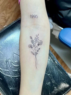 A tattoo of flowers on the arm.